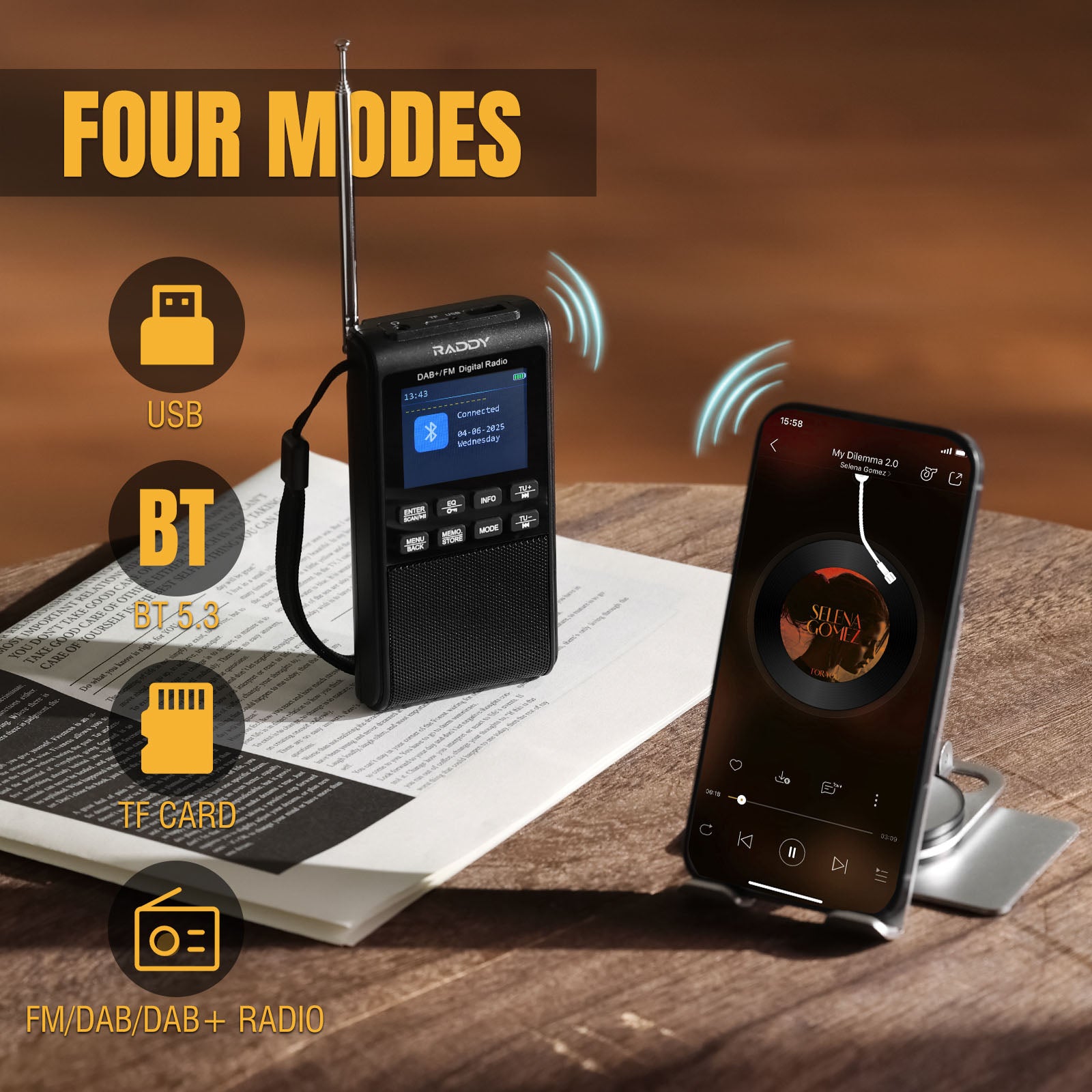 Raddy RD939 Portable radio receiver with smartphone on a wooden surface, featuring text 'Four Modes' and icons.